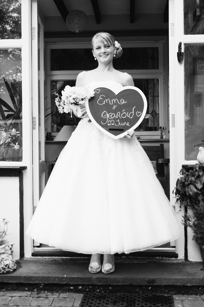 bride with wedding sign heart shaped chalk board